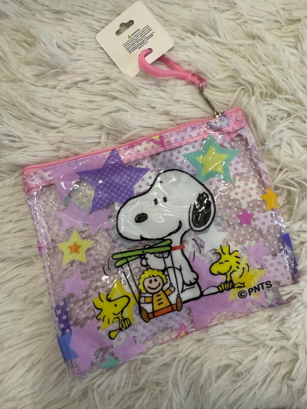 Snoopy clear pouch keychain on purple background with stars and polka dots